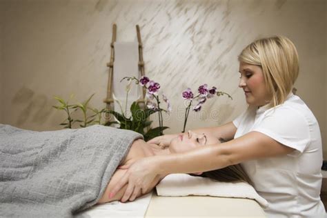 Young Woman Relaxing During Shoulder Body Massage At Spa Stock Photo