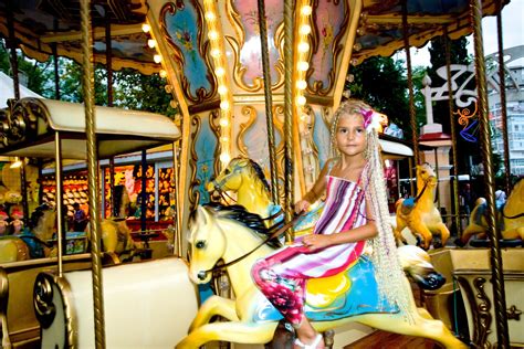 the litlle girl rides a carousel