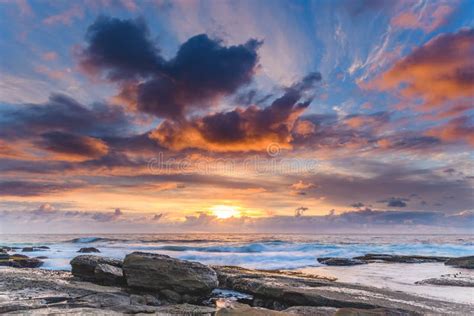 An Atmospheric Sunrise Seascape With Beautiful Clouds Stock Image