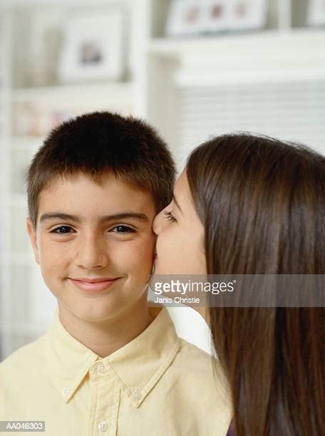 Girl Kissing Cheek Stock Fotos Und Bilder Getty Images