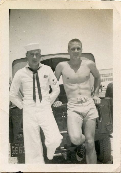 Two Men Standing Next To Each Other In Front Of A Truck Wearing Sailor