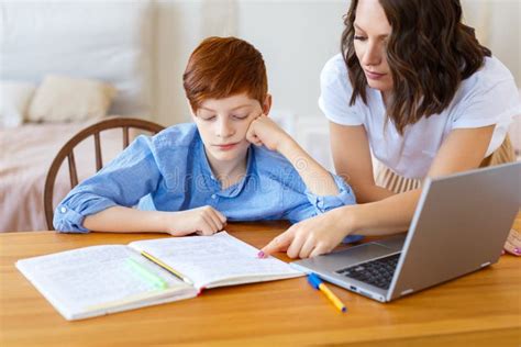 Mom Helps Her Son With Online Homework Close Up Photo Stock Image