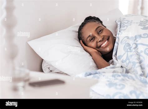 Smiling Young African Woman Waking Up In Her Bed Stock Photo Alamy
