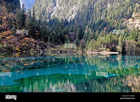 The Stunning Colors Of Autumn Reflect In The Crystal Clear Emerald