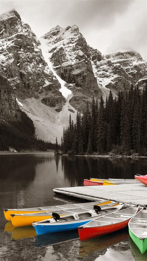 Moraine Lake And Boats With Snow Capped Mountain Banff National Park