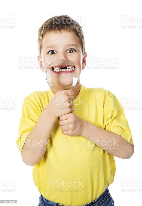Boy Showing Teeth Through A Magnifying Glass Stock Photo - Download ...