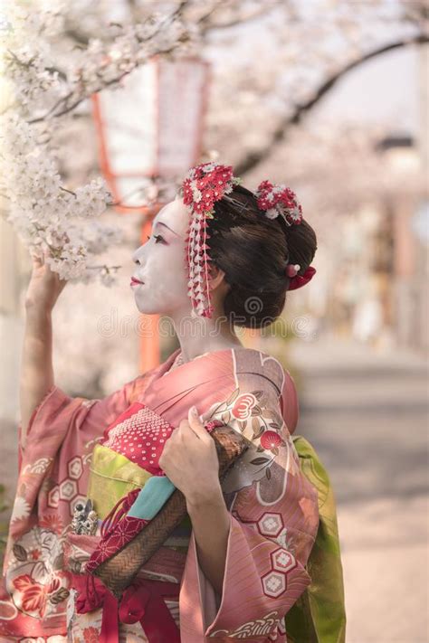Cute Japanese Geisha Maiko Girl In Kimono Posing In Profile Admiring