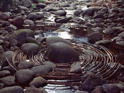 Andy Goldsworthy Abrams Curved Sticks Surround A River Boulder In