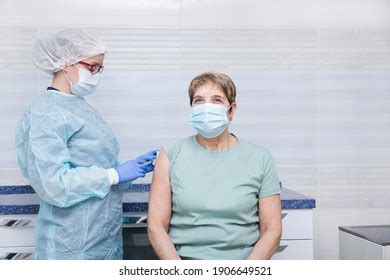 Doctor Giving Injection Senior Woman Hospital Stock Photo