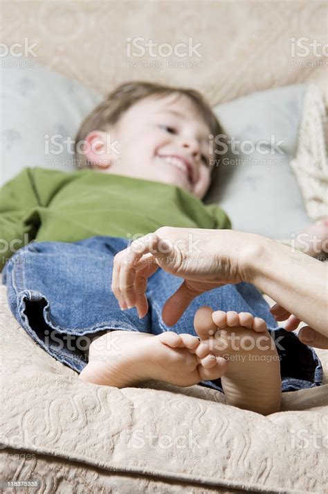 Child Getting Feet Tickled Stock Photo Download Image