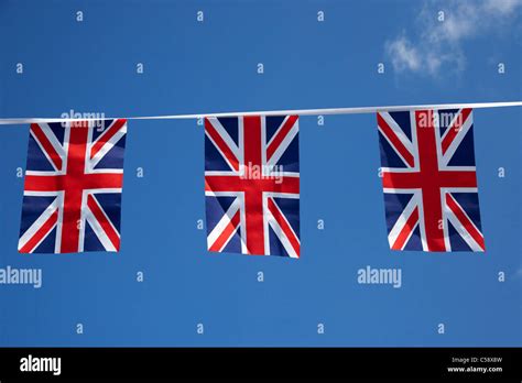 British Union Flag Banner Bunting Flying Against A Blue Sky In The Uk