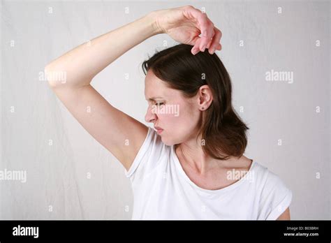 Young Woman Smells Armpit With Disgust And Smells Strong Under Arm