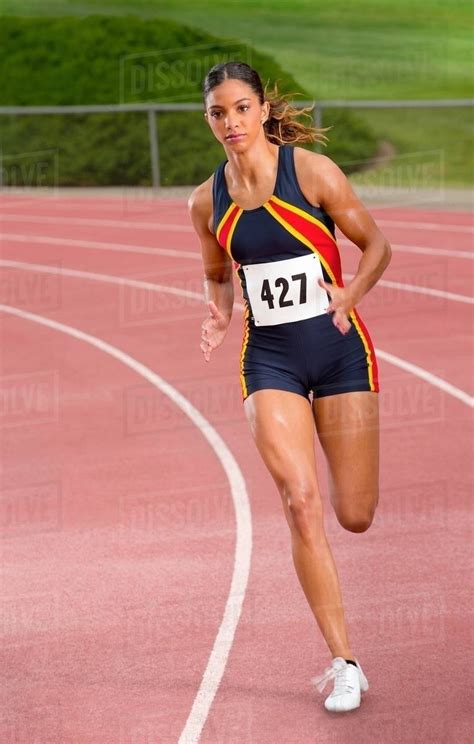 Female Athlete Running On Track Stock Photo Dissolve