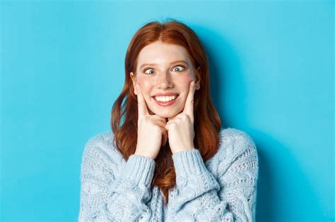 Premium Photo Close Up Of Funny Redhead Teen Girl Making Faces Squinting And Squeezing Cheeks