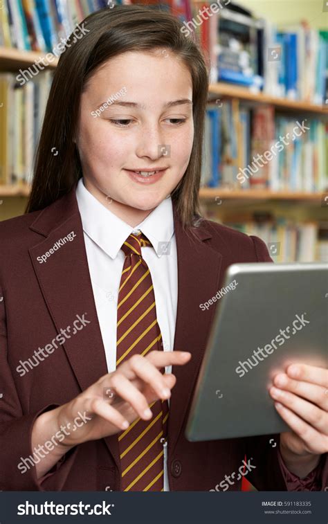 Girl Wearing School Uniform Using Digital Stock Photo 591183335