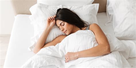 Portrait Of Peaceful Beautiful Woman Sleeping Alone At Home In Bedroom On White Clean Bed Linen