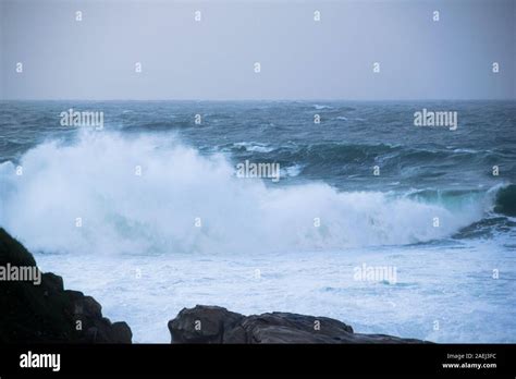 Big Wave Crashing And Splashing Against The Rocks Stock Photo Alamy