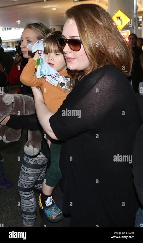 Adele Arrives At Los Angeles International Lax Airport Carrying Her