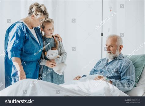 Young Girl Grandmother Supporting Dying Grandfather Stock Photo