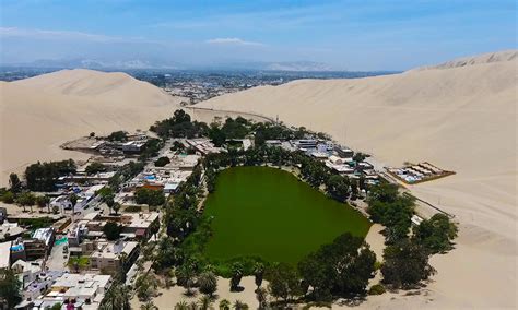 How To Visit Huacachina Perus Desert Oasis Amidst Sand Dunes