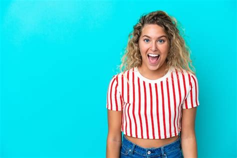 Premium Photo Girl With Curly Hair Isolated On Blue Background With Surprise Facial Expression