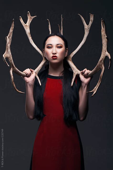 Portrait Of Asian Girl Holding Antlers By T Rex And Flower Stocksy United