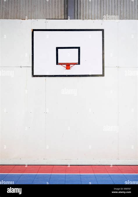 Empty Basketball Court With Basketball Hoop Hanging On Wall Stock Photo