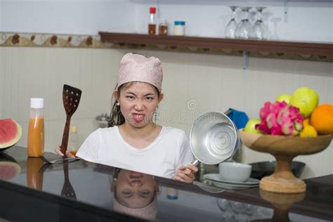 Beautiful Overwhelmed And Stressed Chinese Girl Working In Kitchen