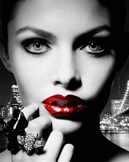 A Woman With Red Lipstick And Jewels On Her Finger In Front Of A Cityscape