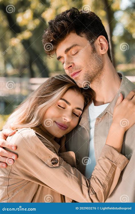 Girlfriend Hugging Boyfriend With Closed Eyes Stock Photo Image Of
