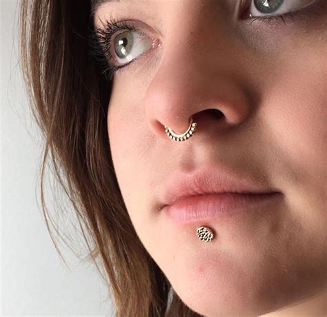 Septum Piercing With A Rose Gold Latchmi Ring And A Labret Piercing