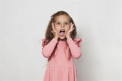 Portrait Of Surprised Little Girl Against White Background Stock Image