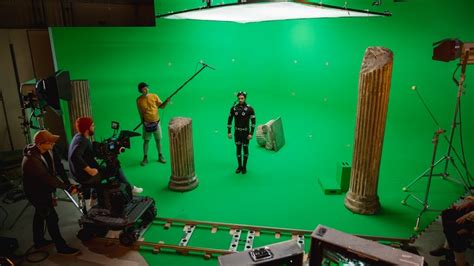 Film Crew Shooting A Scene With A Green Screen