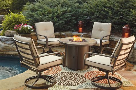 Predmore Beige And Brown Outdoor Round Fire Pit Table From Ashley