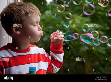 Portrait Of A Young Boy Blowing Bubbles Stock Photo Alamy