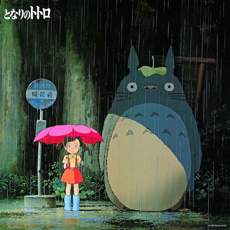 A Person Holding An Umbrella Standing In The Rain With A Totoro Behind Them