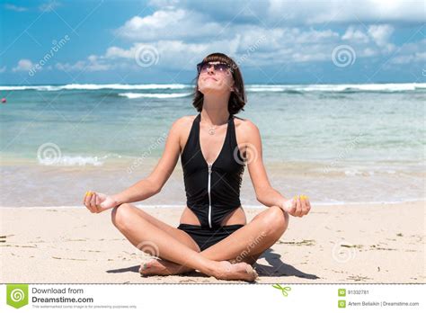 To prepare your body for this. Yoga In The Sea Or Ocean Beach. Girl Meditating In Lotus ...