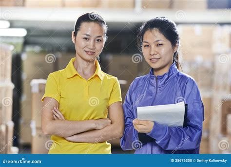 Two Chinese Female Workers In Warehouse Stock Photo Image Of