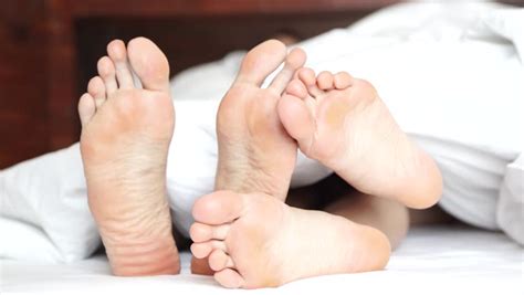 pair feet playing footsie under covers stock footage video 100 royalty free 26306723