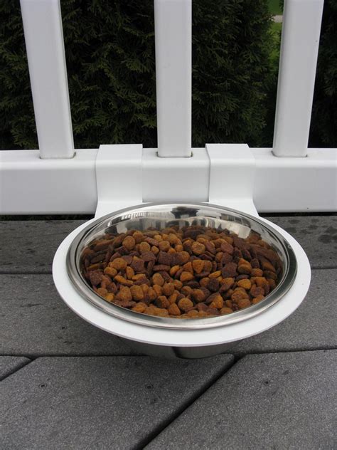 By lifting your dog's food dish up off the ground, you may find that he doesn't create as much of a mess when you feed him. Dog Food / Water Bowl Fence Attachment - by Discount Fence ...