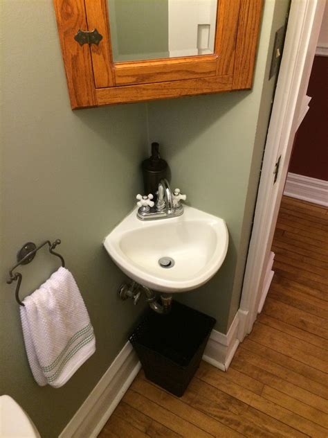 Small Powder Room Demands A Small Corner Sink Hung Low On The Wall