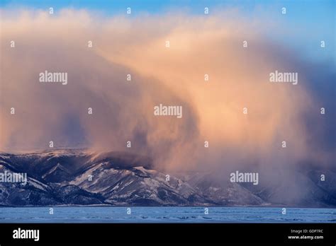 Low Storm Clouds Rolling Over Snow Capped Mountains Baikal Lake