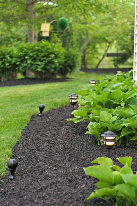 On this walkway, the offset lights have considerable distance between them, leading the eye naturally down the path. DIY Landscaping Lighting Tutorial - Beneath My Heart