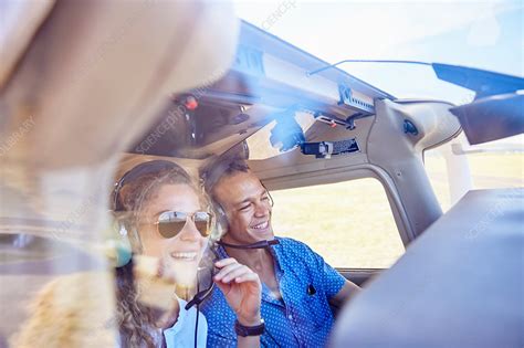 Happy Pilot And Copilot Couple Flying Airplane Stock Image F022