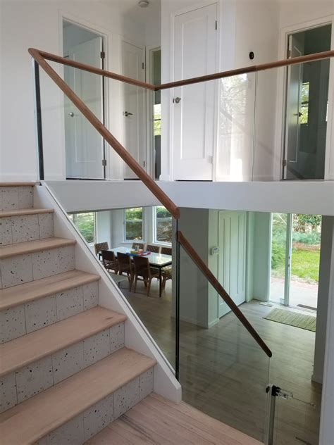 minimal glass railing with a wood cap rail in 2022 glass railing stairs glass stairs glass