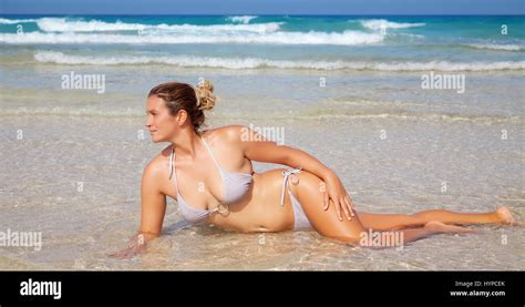 Attractive Woman Wearing A Bikini Lying On The Beach Stock Photo Alamy