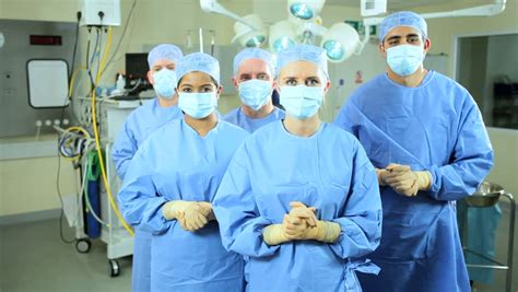 Portrait Female Caucasian Nurse Wearing Full Surgical Scrubs With Team