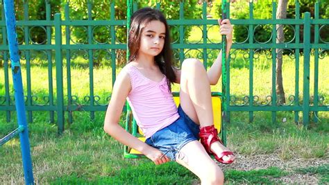 Sad babe Girl On Swing In Summer Park Стоковые футажи для видео Shutterstock
