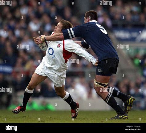 Englands Jonny Wilkinson Left Is Caught Across The Neck By The Arm