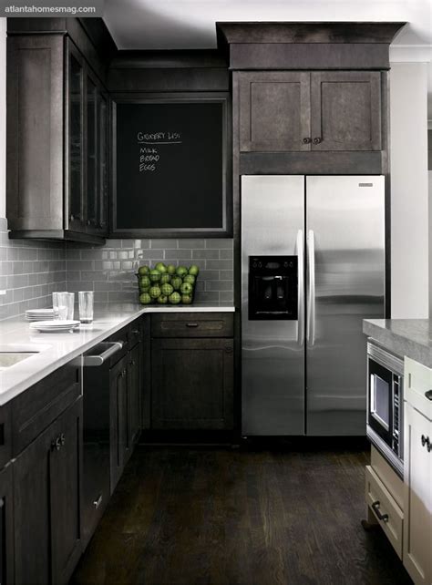 The wall white cabinets and the gray backsplash tiles complement the island cabinets and the marble countertop! Dark, rustic wood mixed with modern elements #gray #white ...